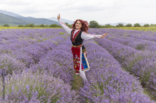 Fototapeta Naklejka Na Ścianę i Meble -  Happy Bulgarian girl in a lavender field
