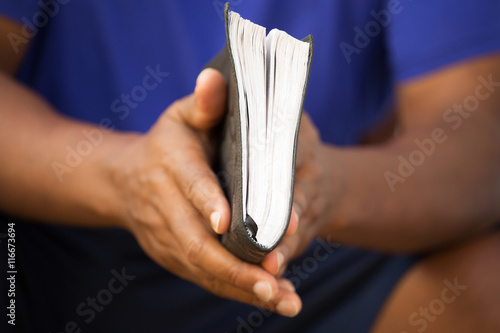 Man holding a Bible.