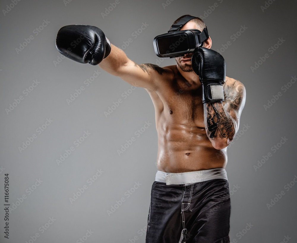 Shirtless brutal boxing fighter in virtual reality glasses.