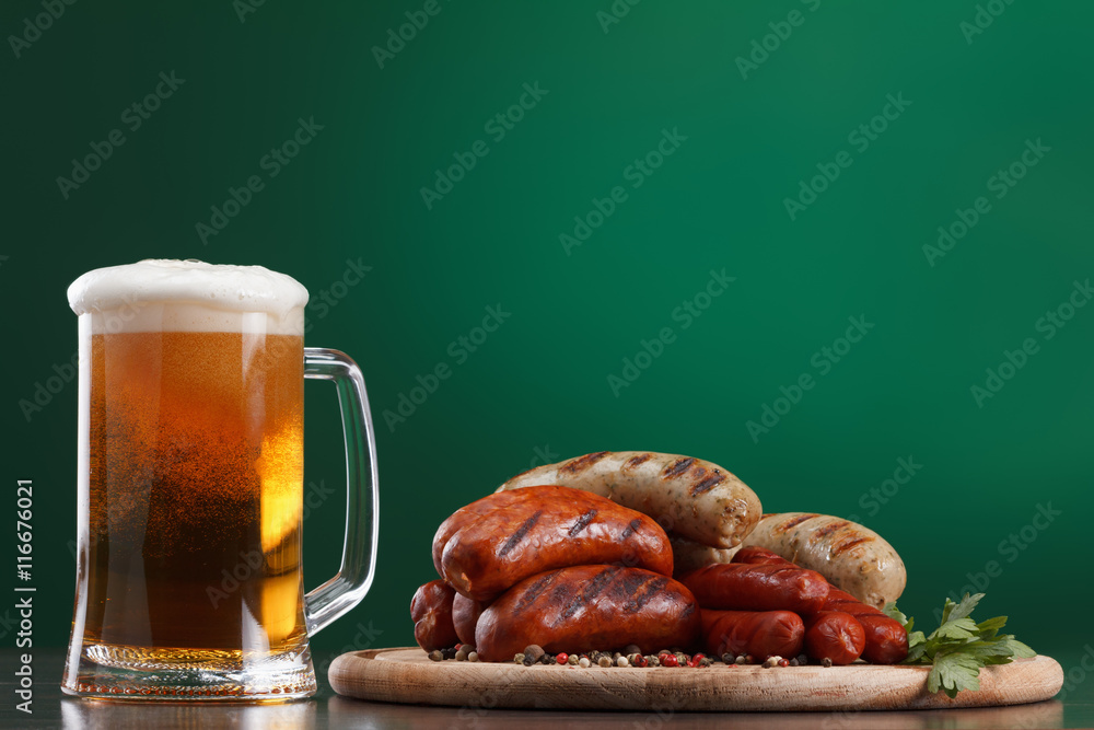 Grilled sausages with glass of beer Grilled sausages with glass of beer