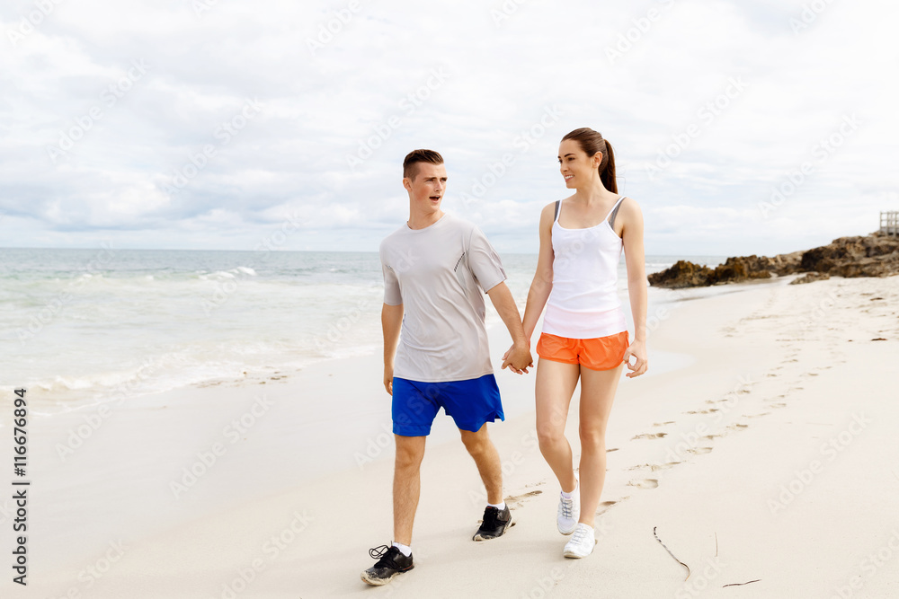 Runners. Young couple running on beach Runners. Young couple running on beach