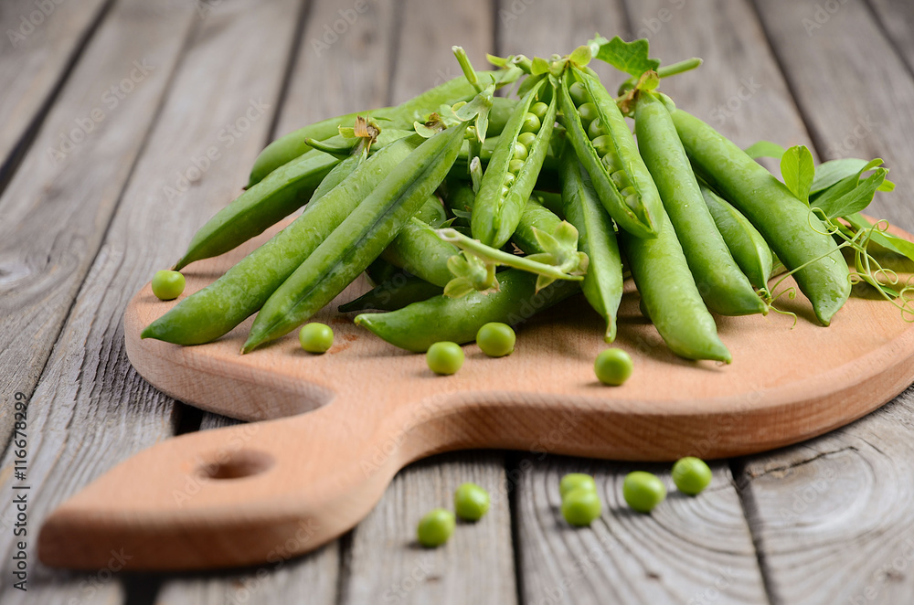 Fresh green peas on rustic wooden background, selective focus, copy space Fresh green peas on rustic wooden background, selective focus, copy space