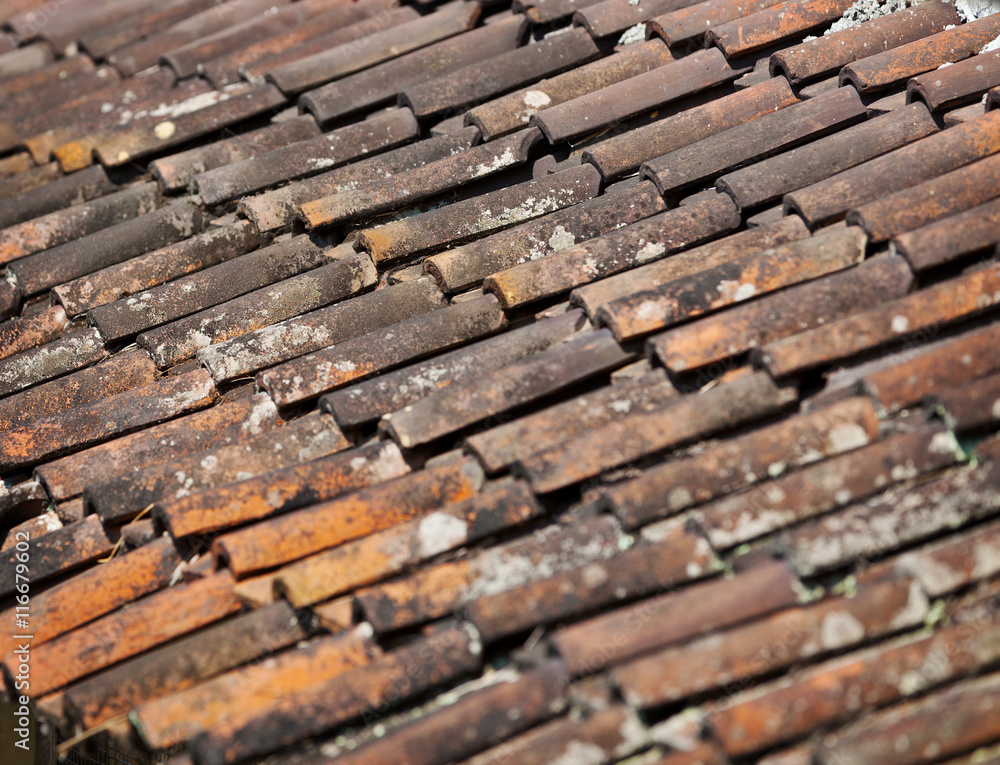 Old red weathered clay tiled roof surface