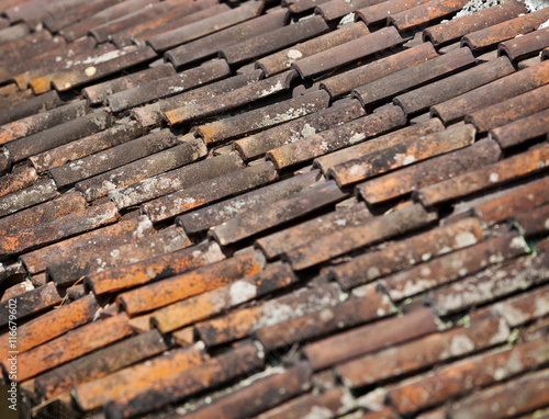 Old red weathered clay tiled roof surface