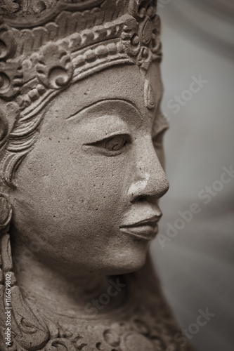 Stone woman face closeup. Indonesia.