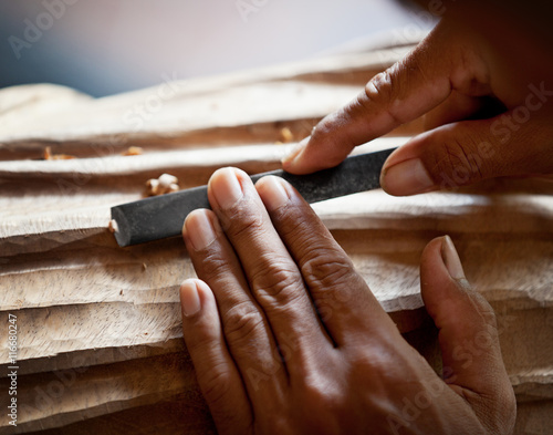 Fototapeta Hands woodcarver with the tool close-up