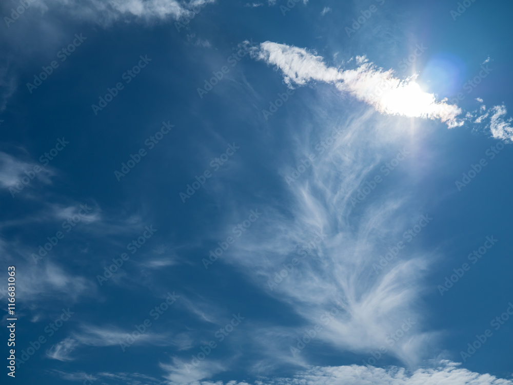 Blue sky with sun and clouds. With lens flare effect. Blue sky with sun and clouds. With lens flare effect.