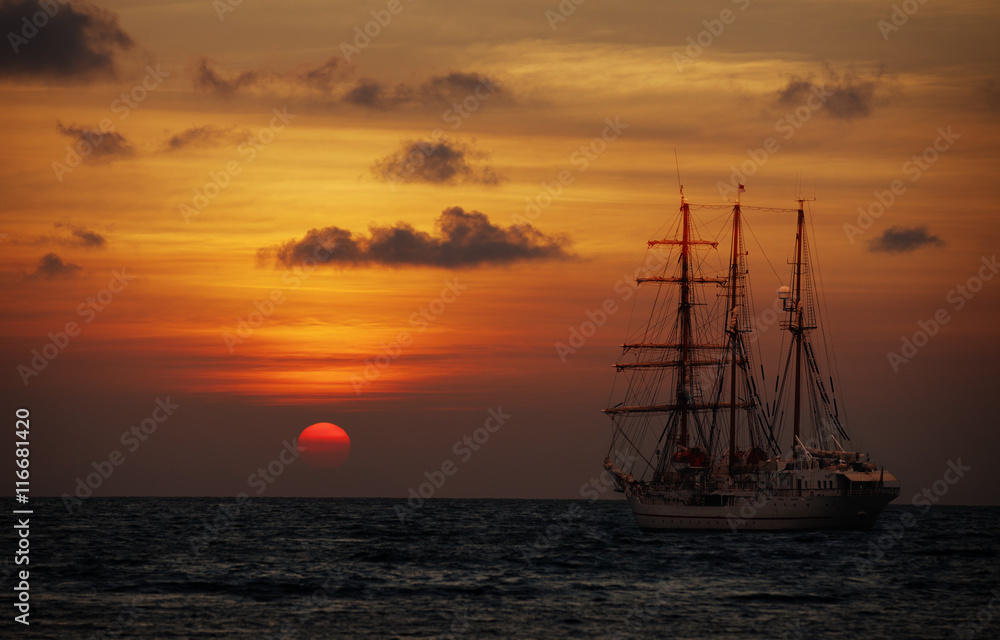 Old sailing ship in the sea at sunset. Barquentine
