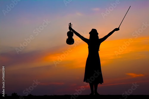 The silhouette of asian woman with the violin