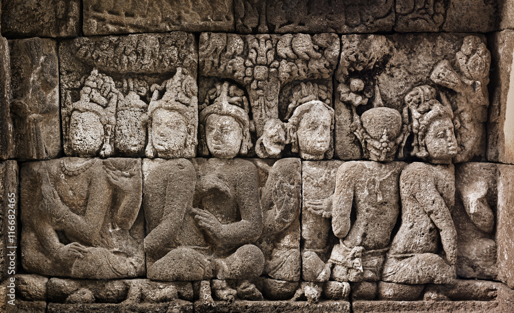 Buddhist carved relief at medieval Borobudur temple on Java, Ind