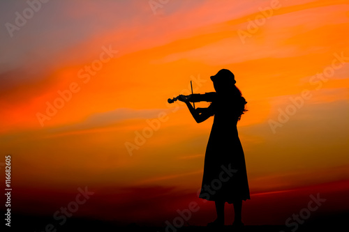 The silhouette of asian woman playing violin