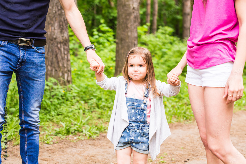 Daughter, parents were holding hands in the park Daughter, parents were holding hands in the park