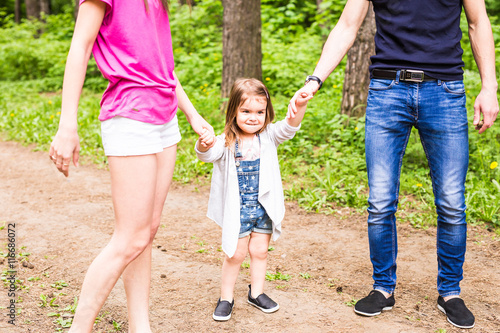 Daughter, parents were holding hands in the park