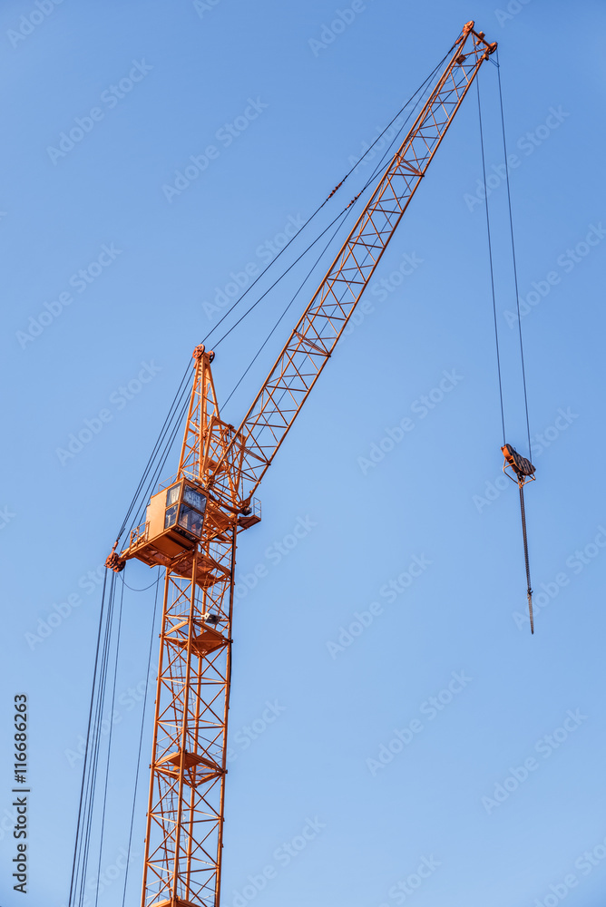 Construction crane. Red construction crane against a clear sky. Construction crane. Red construction crane against a clear sky.