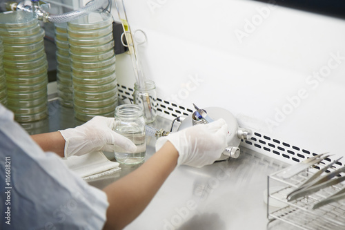 A scientist in lab is burning a knife for hygiene .
