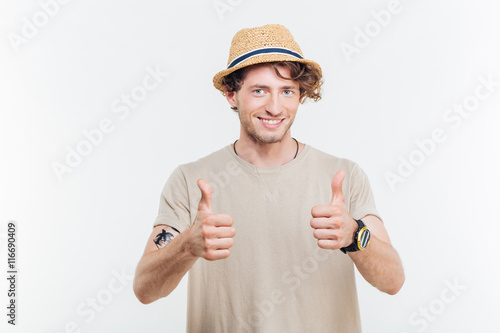 Happy young handsome man showing thumb up