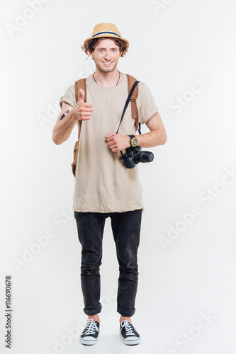 Full length portrait of handsome male tourist looking at camera