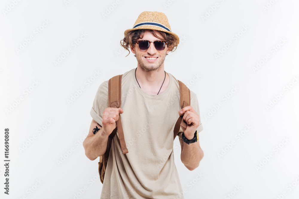 Portrait of happy young man with backpack over white background Portrait of happy young man with backpack over white background