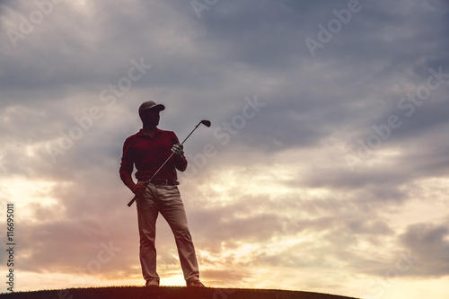 silhouette of man golfer with golf club at sunset
