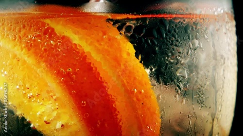 Fresh ice summer cocktail with orange, closeup