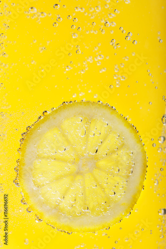 Slice of lemon surrounded by water bubbles