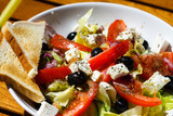 Fresh greek salad with grilled bread for healthy lunch.