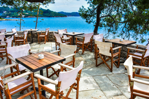 Greek tavern in Skiathos with view over the blue sea photo