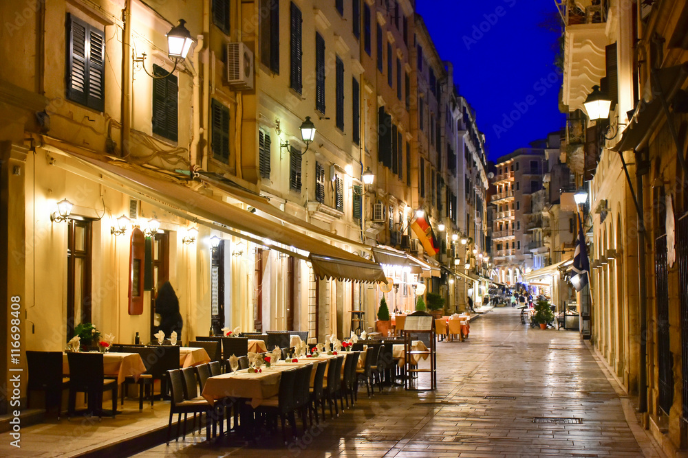 Corfu old town (Kerkyra) city streets at night with restaurants