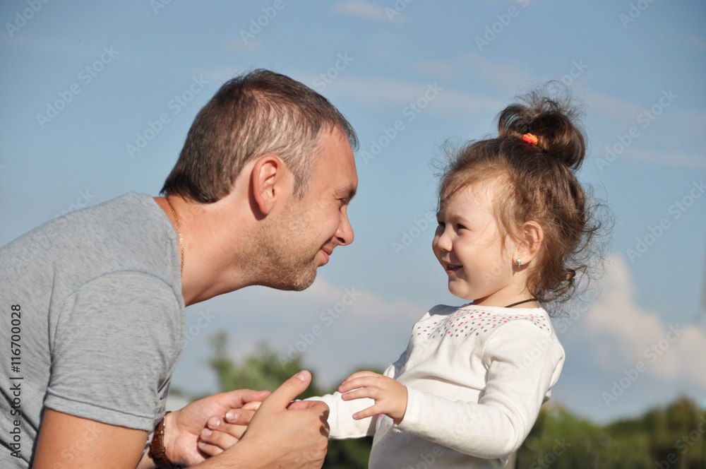 Happy father with his daughter outdoors hugging together Happy father with his daughter outdoors hugging together