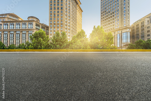 clean asphalt road with city skyline background,china.
