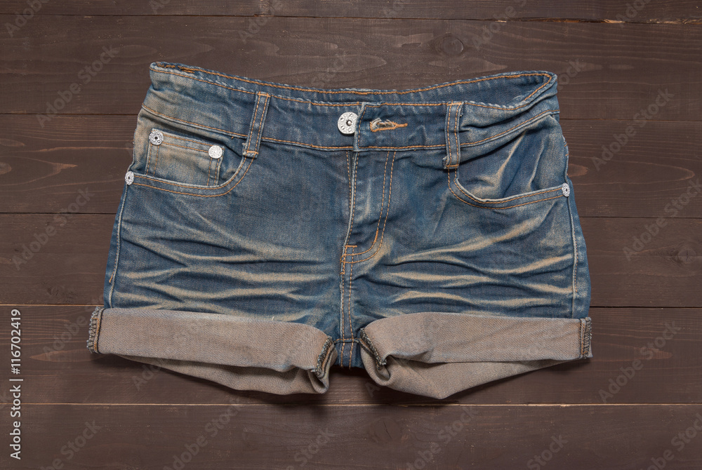 Jeans short is on the wooden background Jeans short is on the wooden background