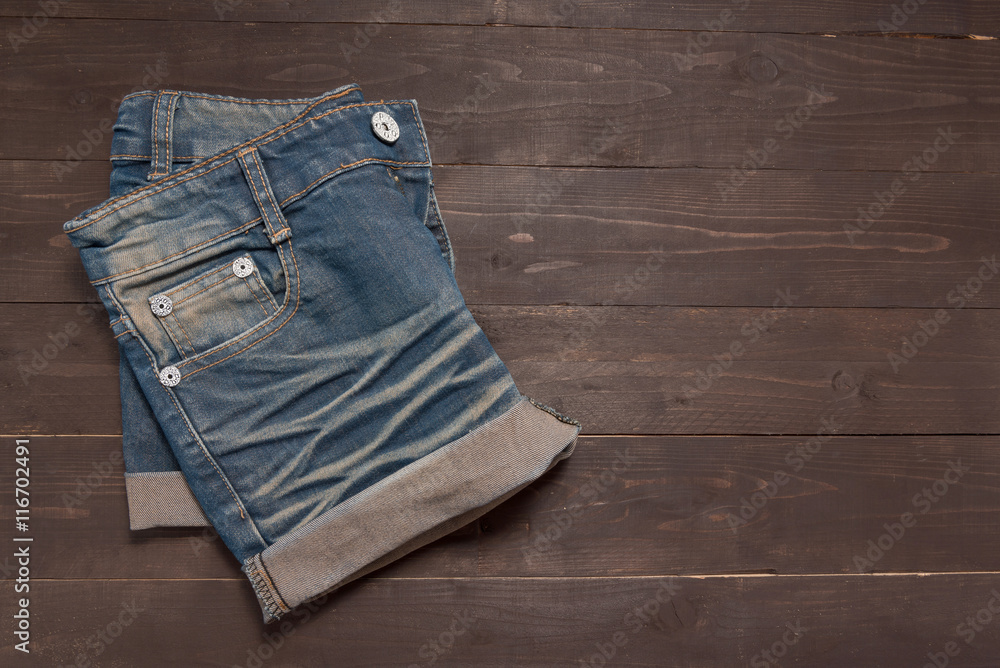 Jeans short is on the wooden background Jeans short is on the wooden background