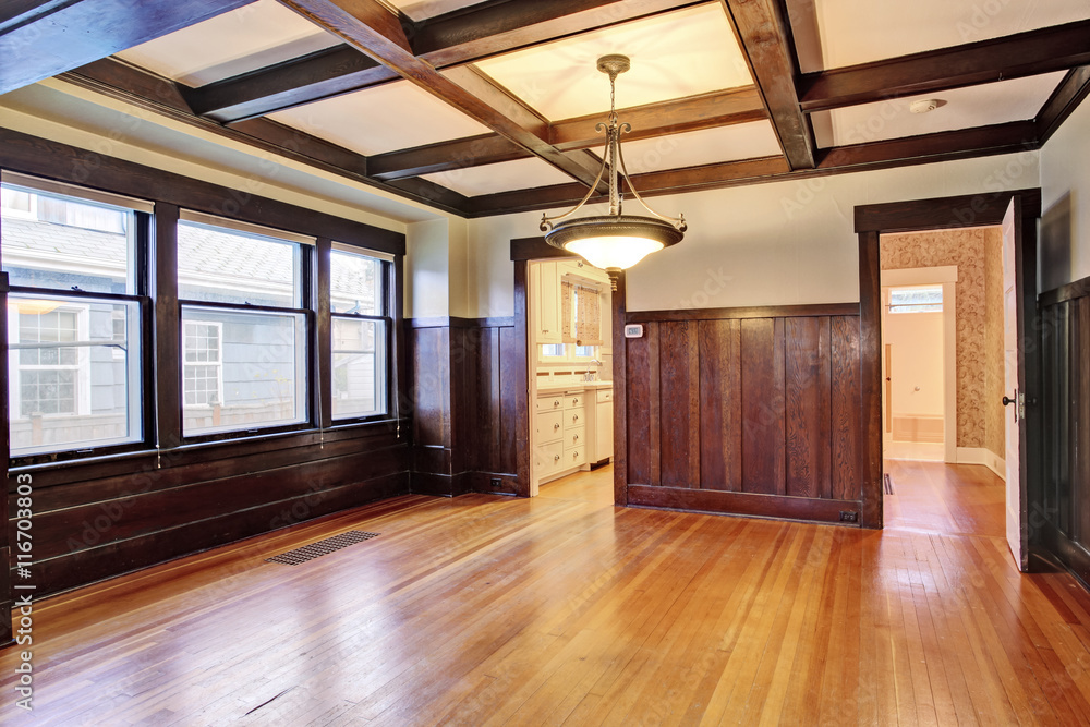 Fototapeta premium Empty room with wood paneled walls and coffered ceiling.