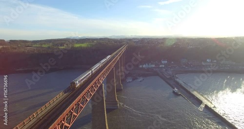 Aerial: Train on Forth Rail Bridge in Queensferry, Edinburgh, Scotland photo