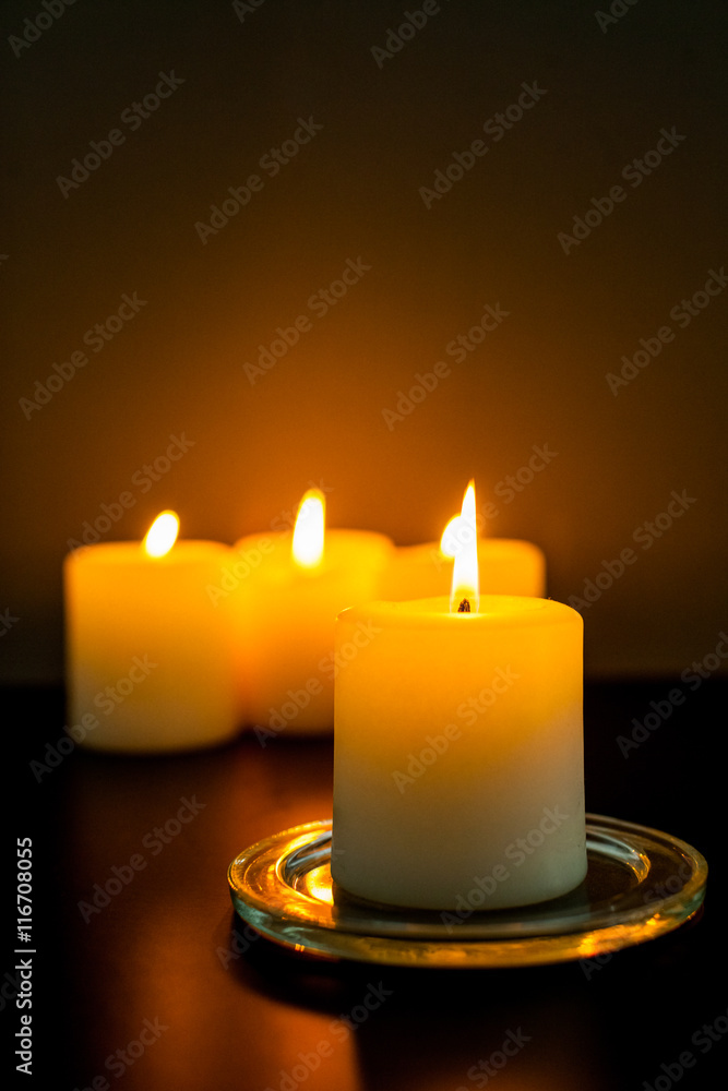 closeup to burning candles in darkness closeup to burning candles in darkness