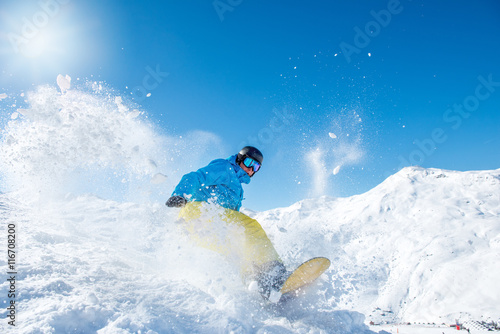 Snowboarder riding down the slope