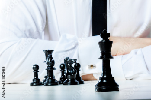 Hand of businessman playing chess