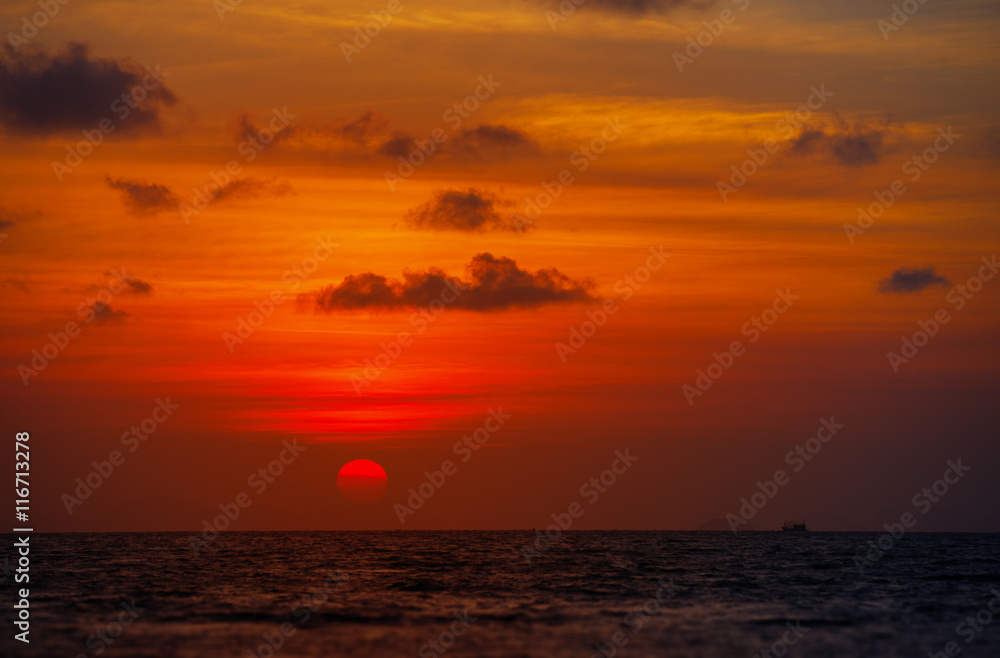 Red Ball of the Sun Dipping towards Horizon at Sunset