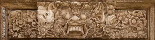 Horrible mythical monster face. Stone relief from Indonesia, Bal