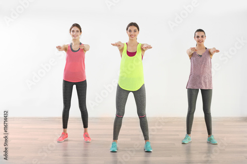 Young women doing exercise in gym
