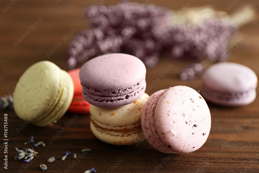 Heap of tasty macaroons on wooden background Heap of tasty macaroons on wooden background