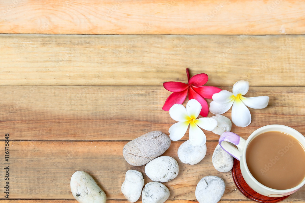 coffee cup with Plumeria flower and stone on wood plate coffee cup with Plumeria flower and stone on wood plate