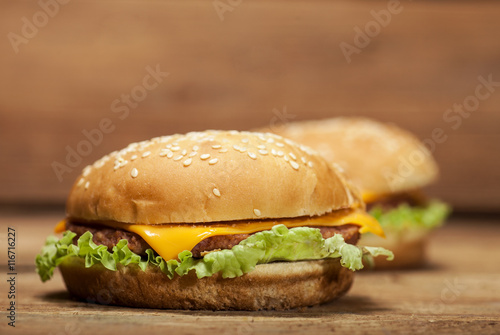 Fresh burgers on wooden background