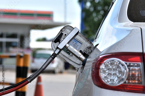 Filling CNG fuel tank at a gas station. photo