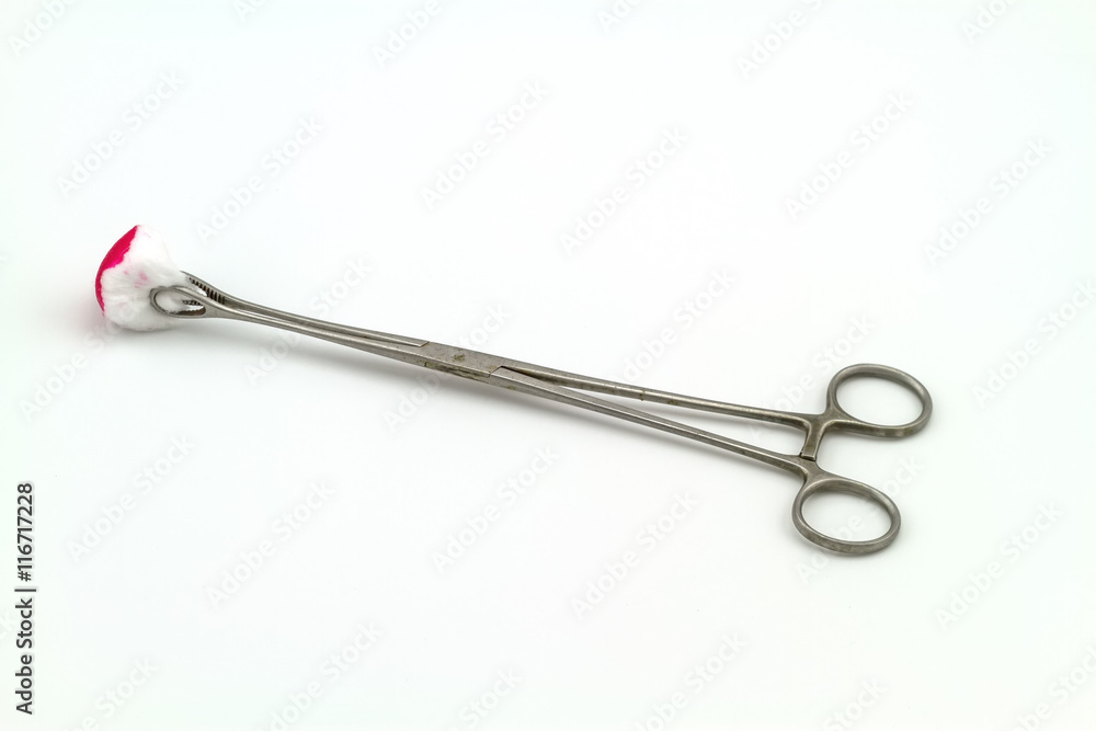 Surgical instrument (straight hemostat, sponge forceps) cotton wool and bloodstain on white background Surgical instrument (straight hemostat, sponge forceps) cotton wool and bloodstain on white background