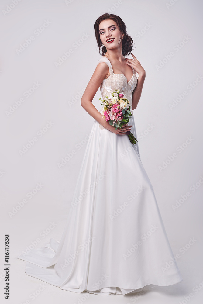 Woman in wedding dress with flowers' bouquet. Woman in wedding dress with flowers' bouquet.