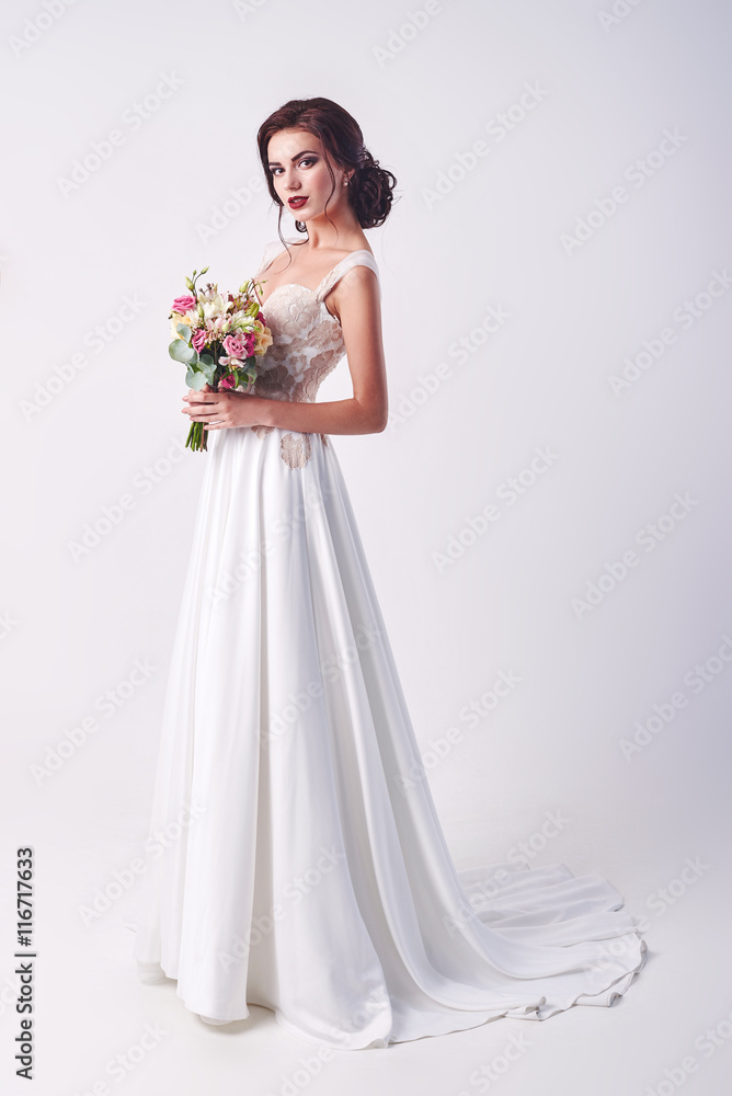 Young attractive bride with the bouquet of white roses Young attractive bride with the bouquet of white roses