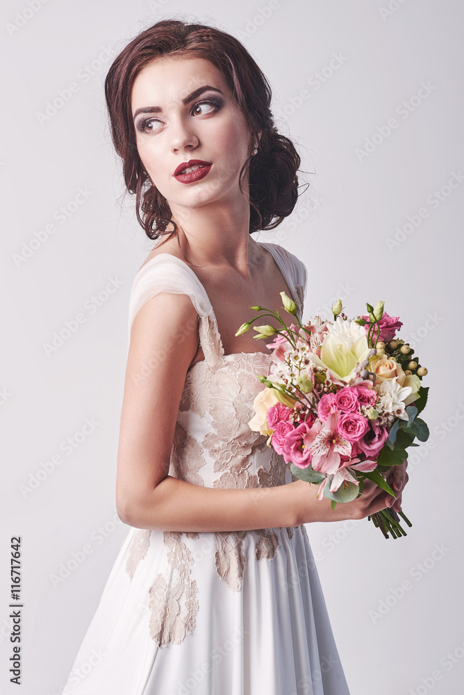 Young attractive bride with the bouquet of white roses Young attractive bride with the bouquet of white roses