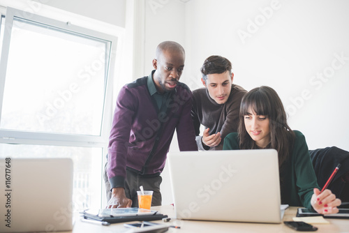 Multiracial business people working together connected with technological devices like tablet and notebook - teamwork, business, working concept