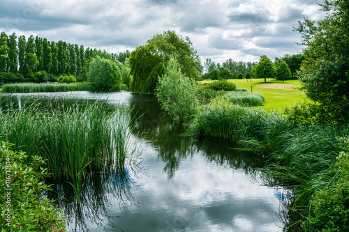 Lake in Campbell park on overcast day in summer, Milton Keynes, UK photo